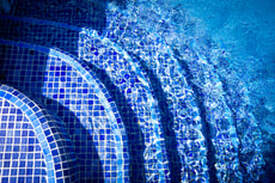 Picture of blue tile pool steps with sparkling water.